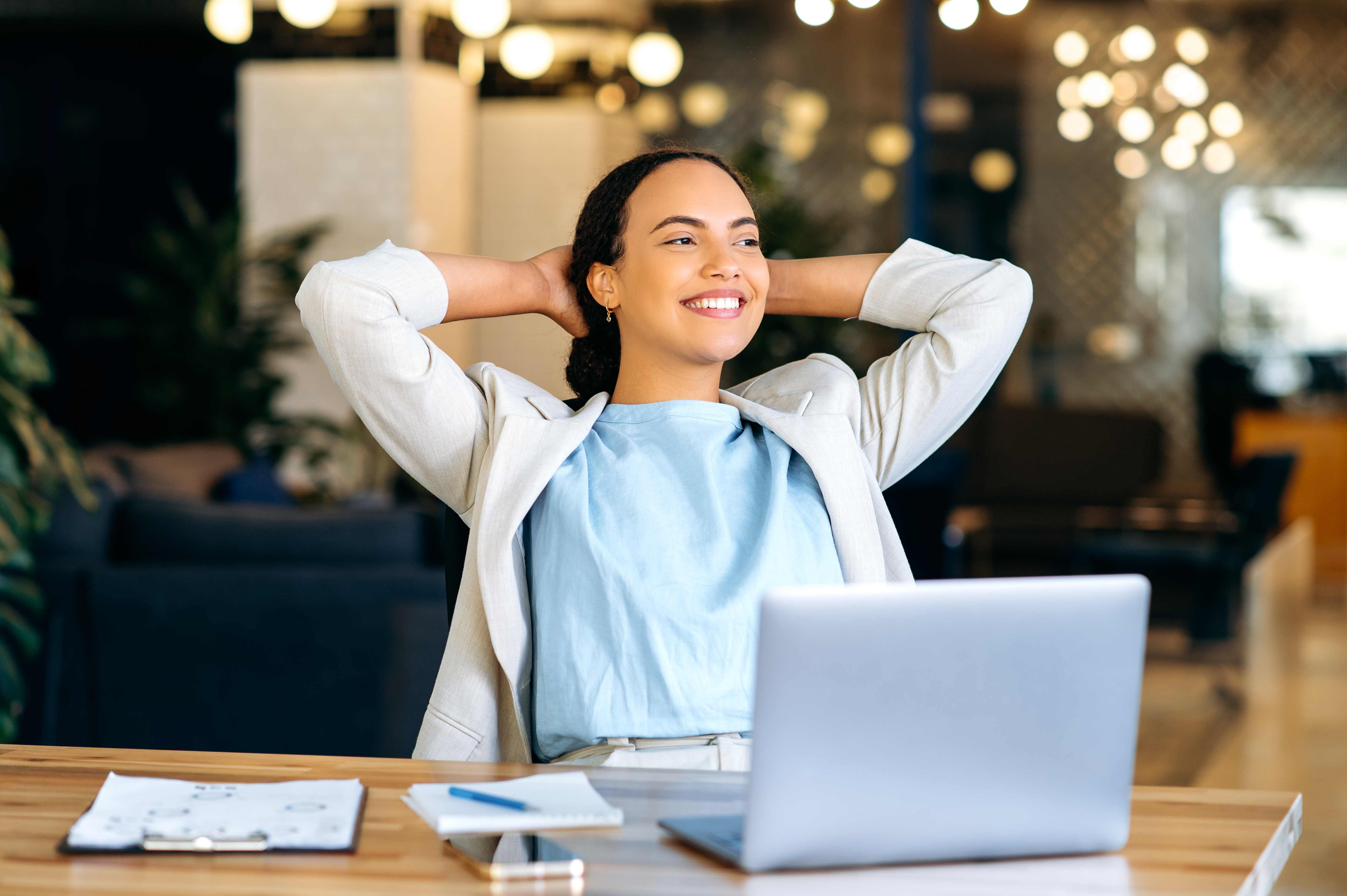 Professional woman relaxing at desk after reclaiming time